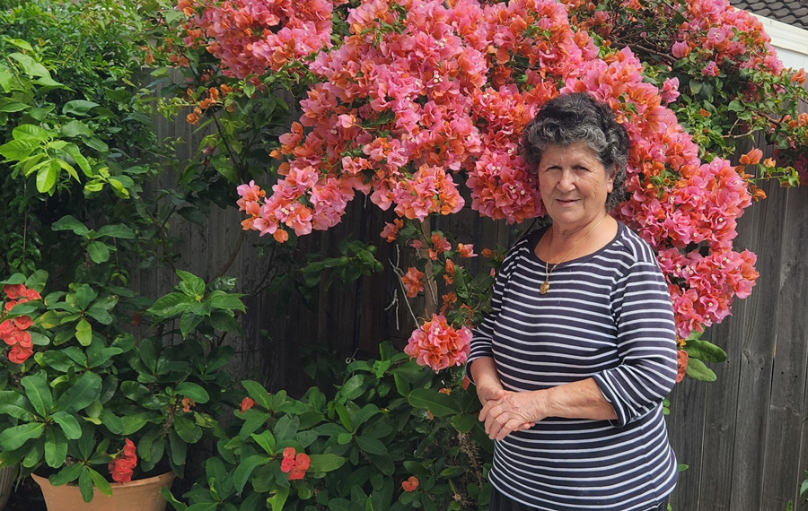 Despina in front of her courtyard garden on the Gold Coast